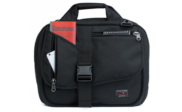 Empire Builder in Black 1050 Ballistic with a guidebook in the top-left front pocket